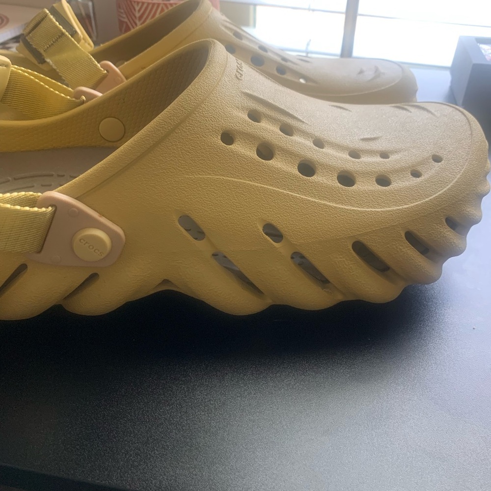 Crocs more of a muted mustard color in my opinion